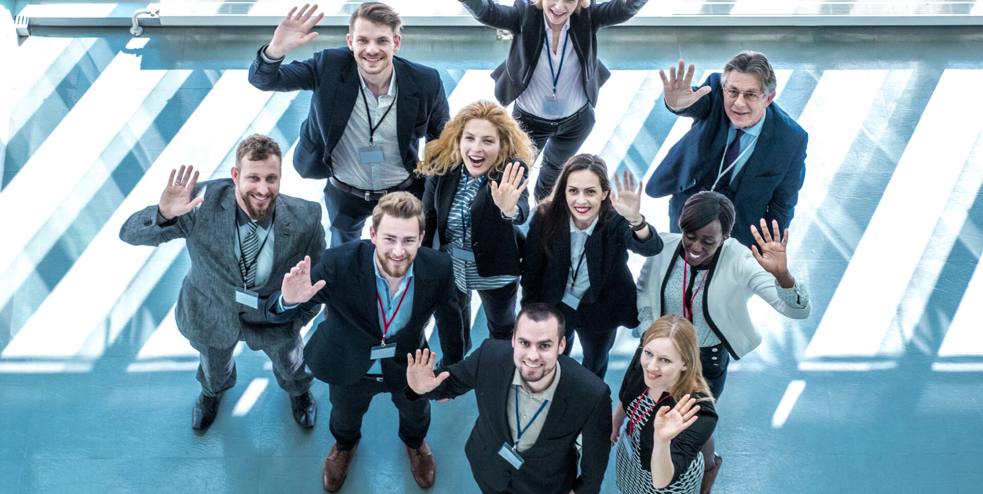 Portrait of waving business people